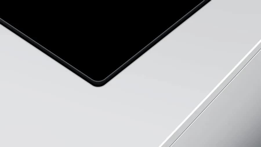 Close-up of a car's black roof and white body