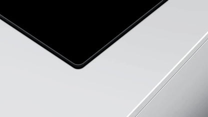 Close-up of a car's black roof and white body