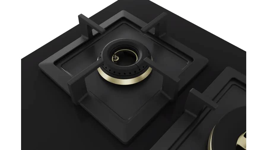 Black gas stove with gold trim on a white background